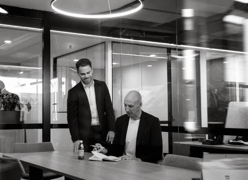 Commercial team analysing leasing plans and floor drawings during a working session.