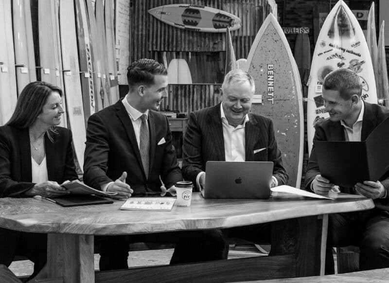 Commercial leasing specialists meeting with a client to review property options and strategy.