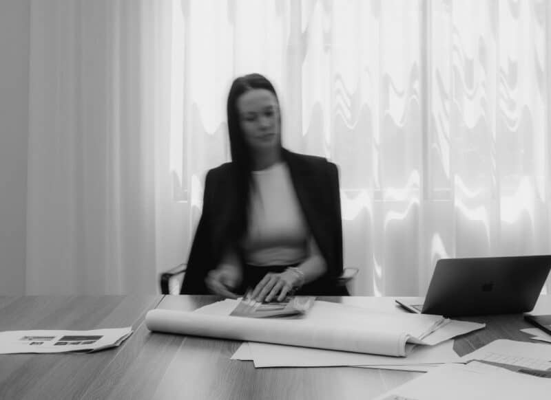 Team member working at a desk reviewing marketing documents