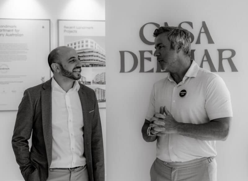 Developers and sales team reviewing documentation together during a project sales meeting.