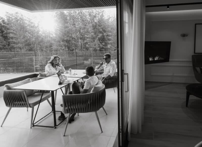 Leasing professionals reviewing documents and outcomes during a residential strategy meeting.